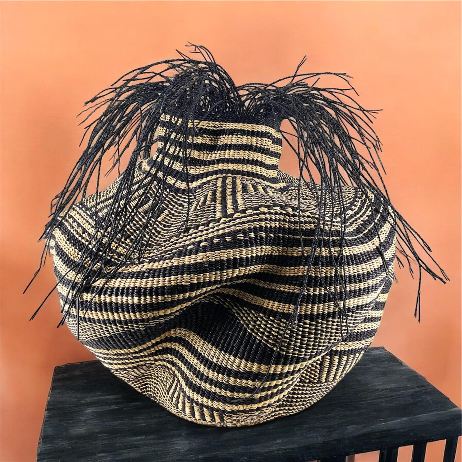 Handwoven Bolga basket with fringed elephant grass rim